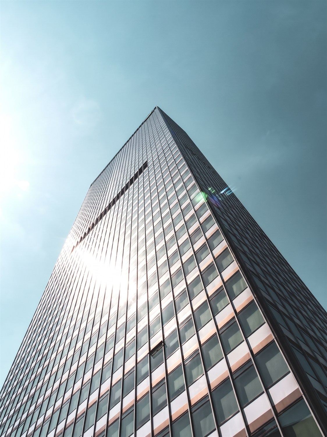 Real Estate — sunlit glass high-rise tower